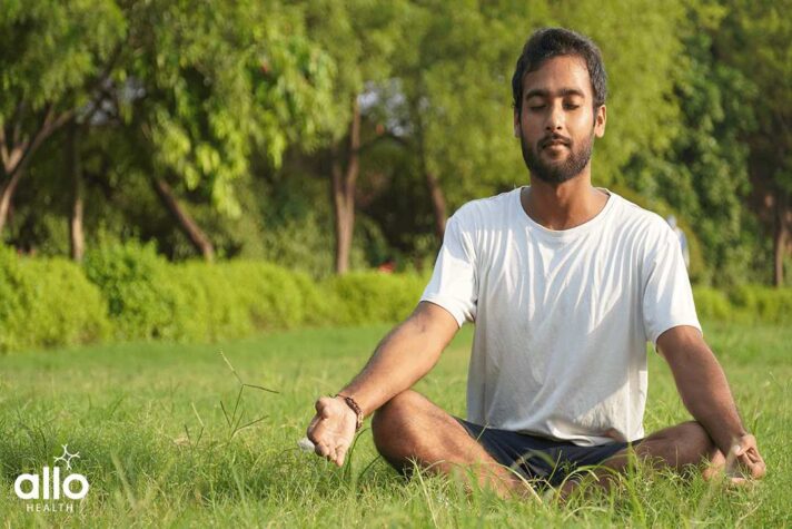 man doing yoga- Man Doing Meditation in Park for preventing Erectile Dysfunction